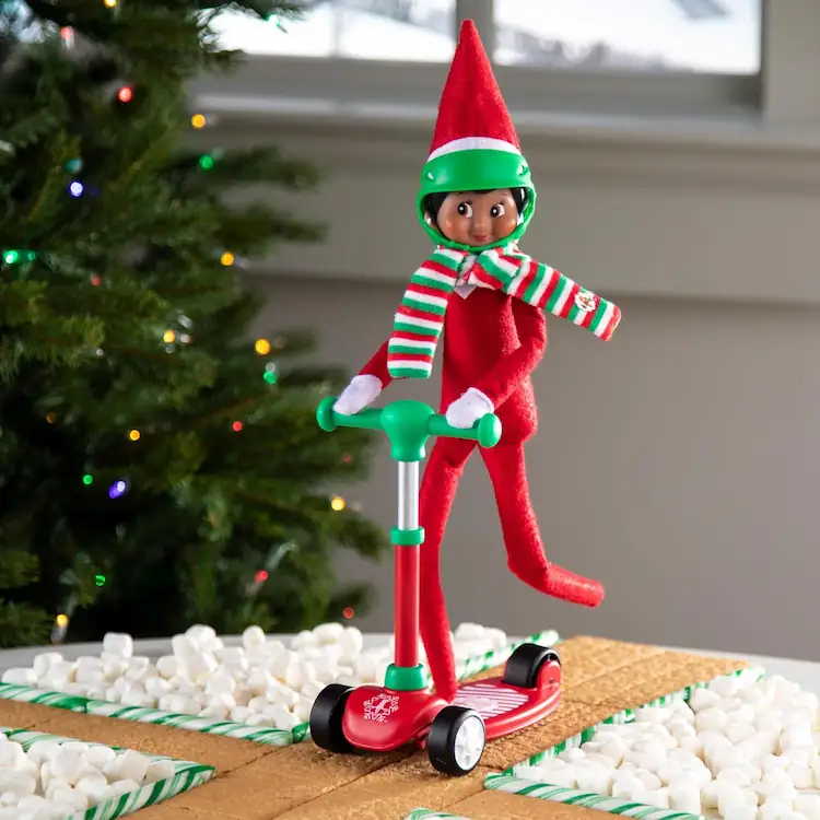 Scout elf doll riding a scooter